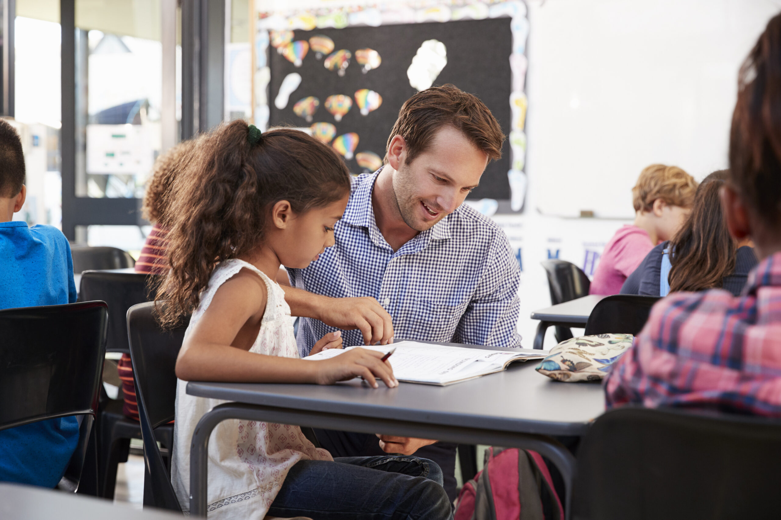 Teacher helping a student in the classroom