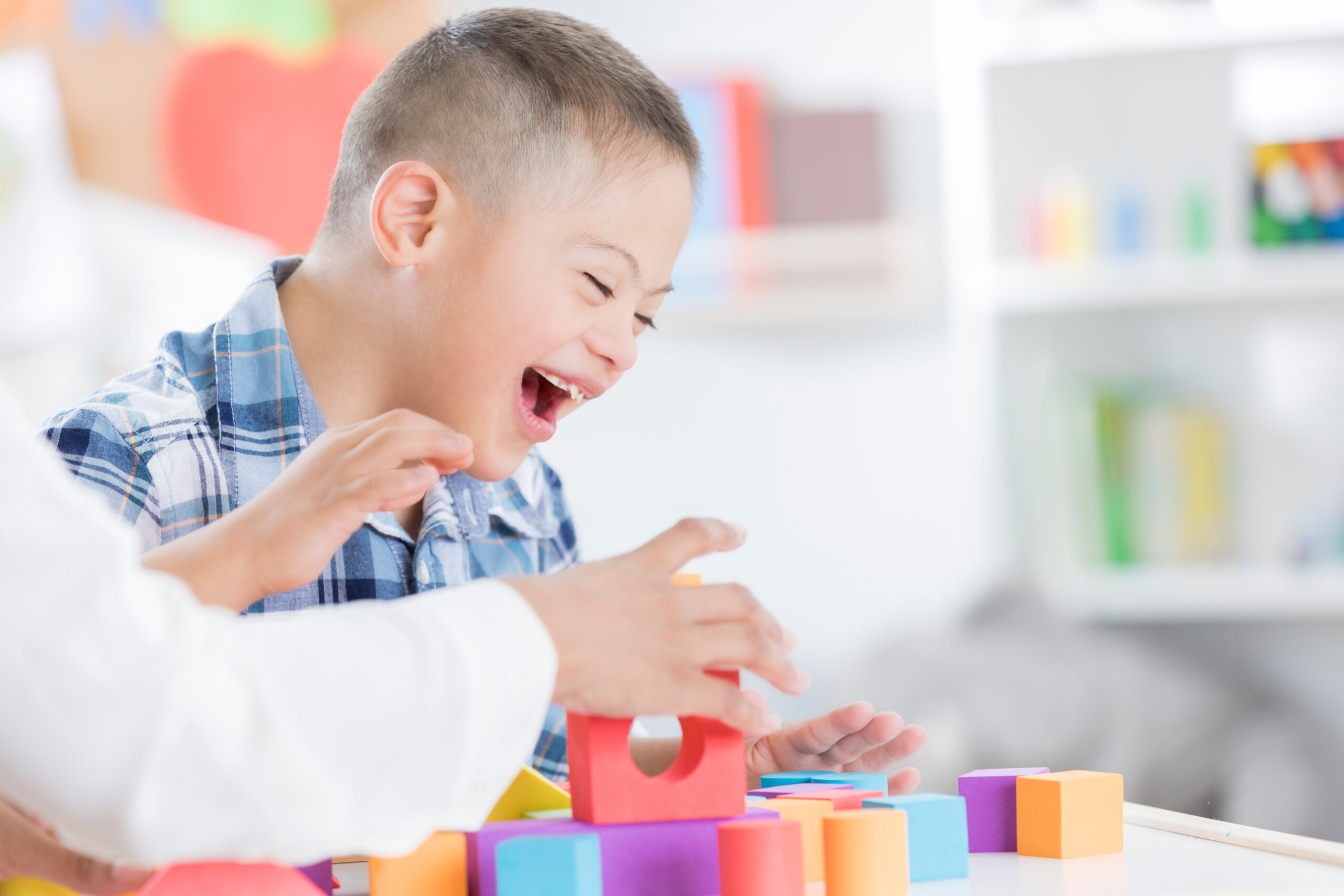 Child with special needs learning with colorful blocks